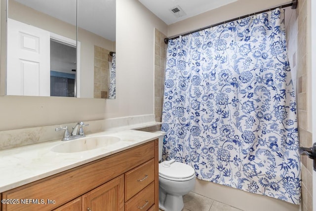 bathroom with toilet, tile patterned floors, and vanity