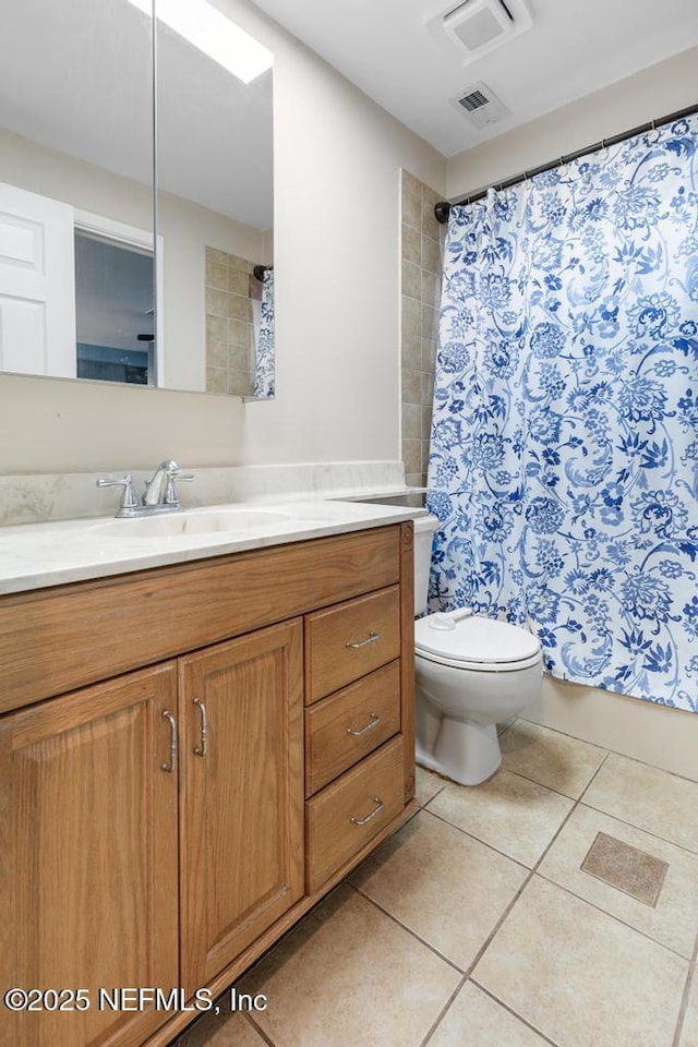 bathroom with toilet, vanity, a shower with shower curtain, and tile patterned flooring