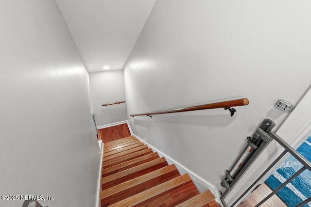 staircase with wood-type flooring