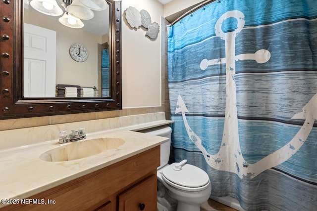 bathroom with toilet, vanity, and a shower with curtain