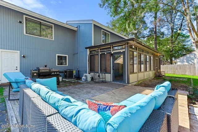 back of property with a patio area, a sunroom, an outdoor hangout area, and central AC unit