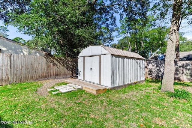 view of outbuilding featuring a yard