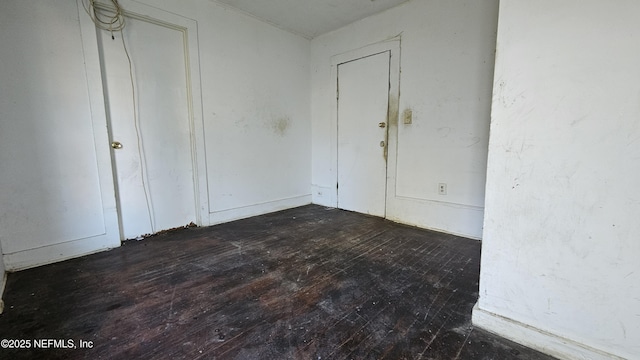 empty room with dark wood-type flooring