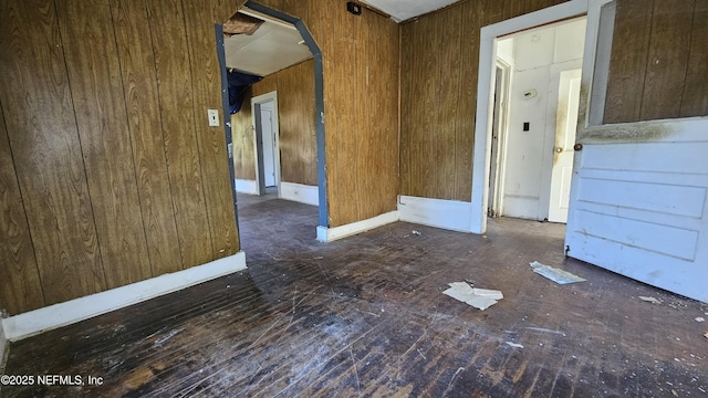 spare room featuring wood walls