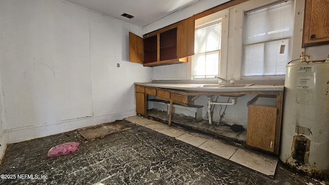 kitchen featuring gas water heater and sink