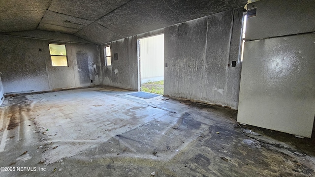 empty room with lofted ceiling