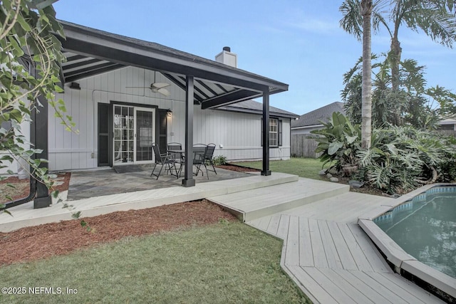 wooden deck with a yard, a patio, and ceiling fan