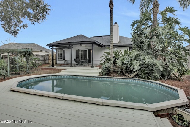 view of pool with a patio, a deck, and ceiling fan