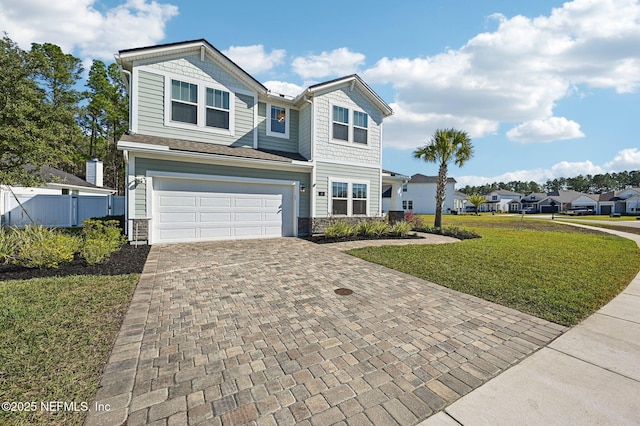 view of front of property featuring a garage and a front yard