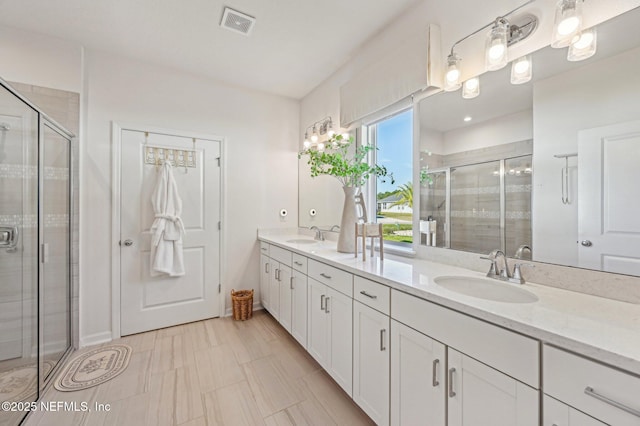 bathroom featuring vanity and an enclosed shower