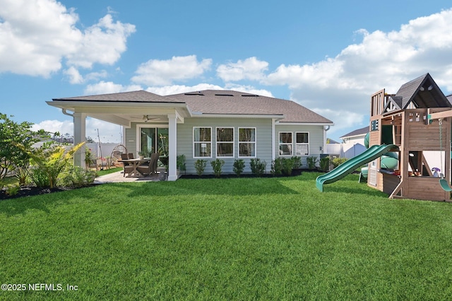 back of property featuring a yard, a playground, and ceiling fan