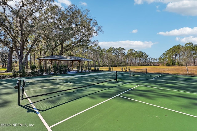 view of tennis court featuring a gazebo