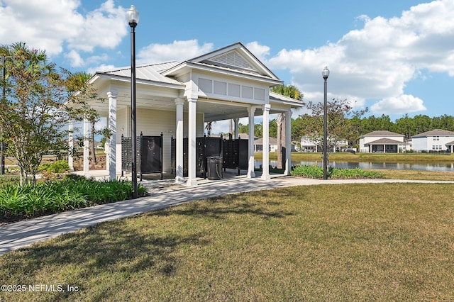 view of property's community with a yard and a water view