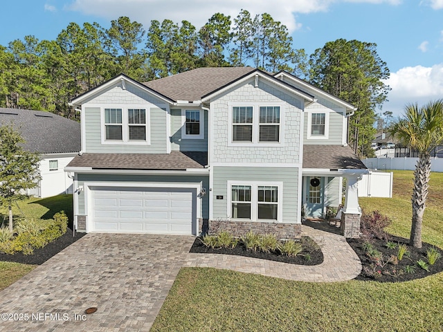 view of property with a front yard and a garage