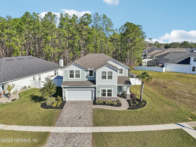 view of front facade with a garage and a front lawn