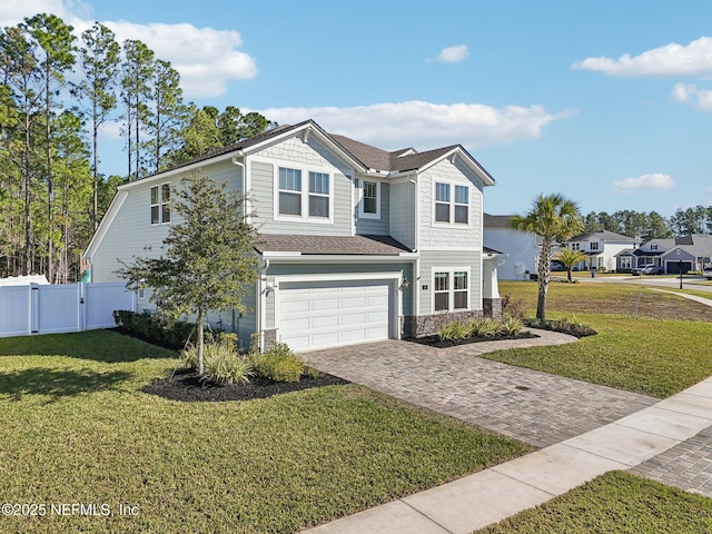 view of front of property featuring a garage and a front lawn