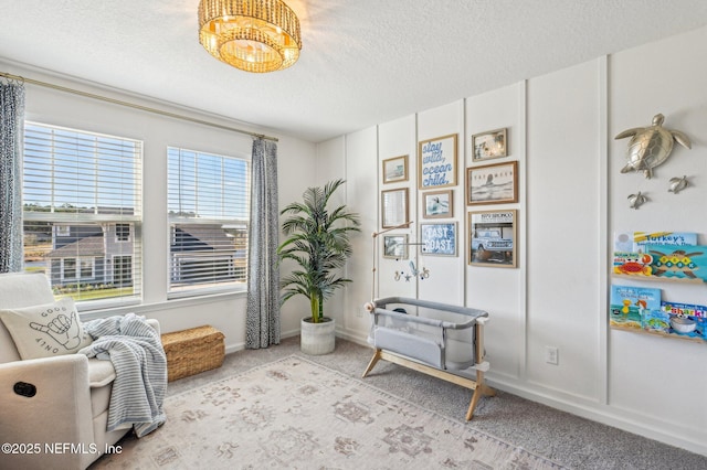 living area with a textured ceiling and light colored carpet