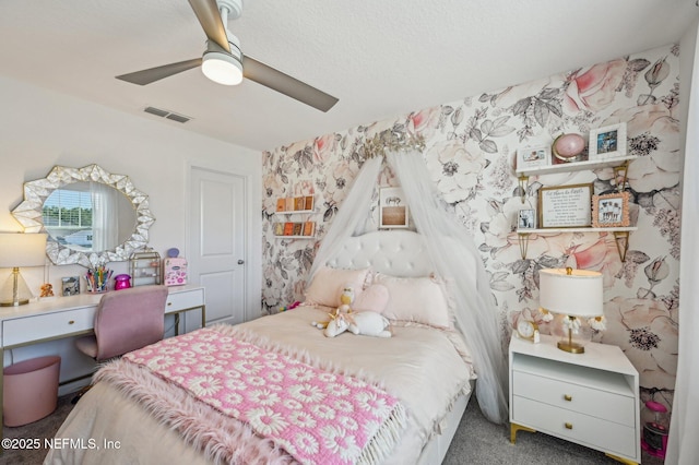 bedroom with ceiling fan, dark carpet, and a baseboard heating unit