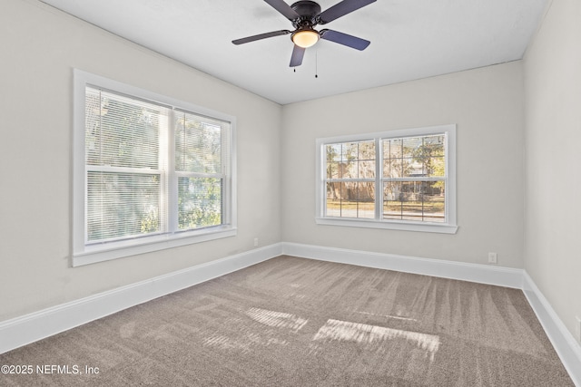 carpeted empty room featuring ceiling fan