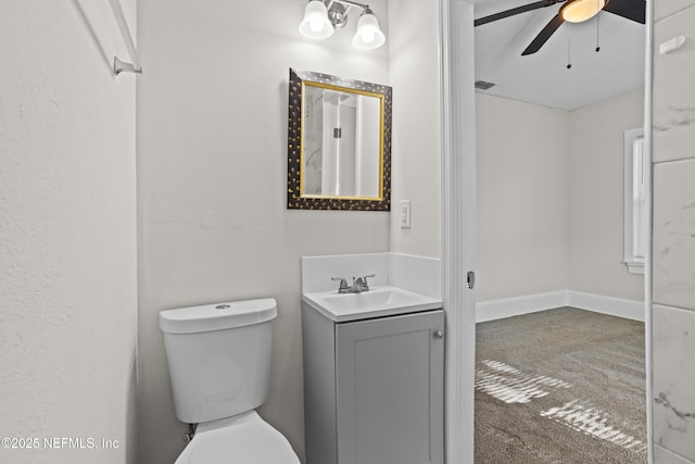 bathroom featuring ceiling fan, vanity, and toilet