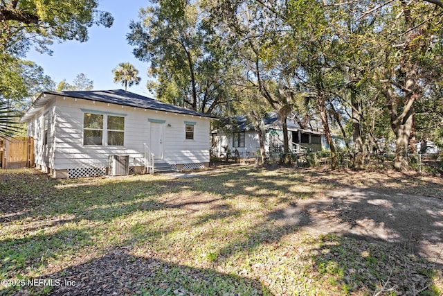 back of house with a lawn