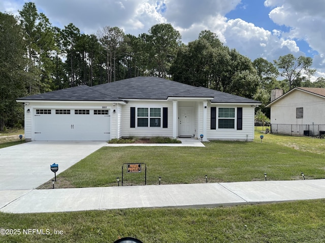 view of front of property featuring a garage and a front yard