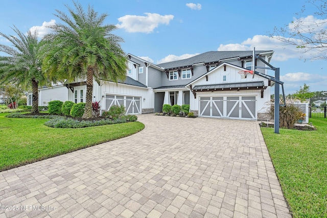 view of front of house with a front yard and a garage