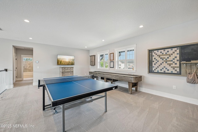 playroom featuring a textured ceiling and light carpet