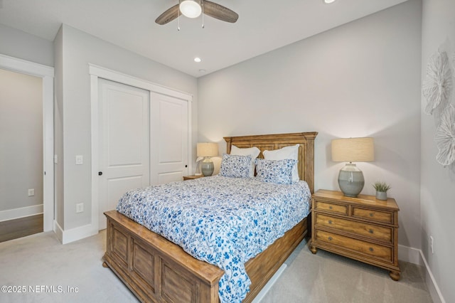 carpeted bedroom with ceiling fan and a closet