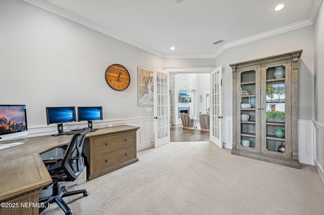 carpeted home office with crown molding and french doors