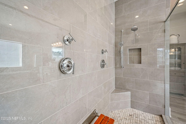 bathroom with tiled shower