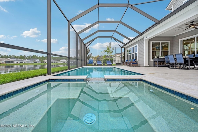 view of pool featuring glass enclosure, ceiling fan, a water view, and a patio