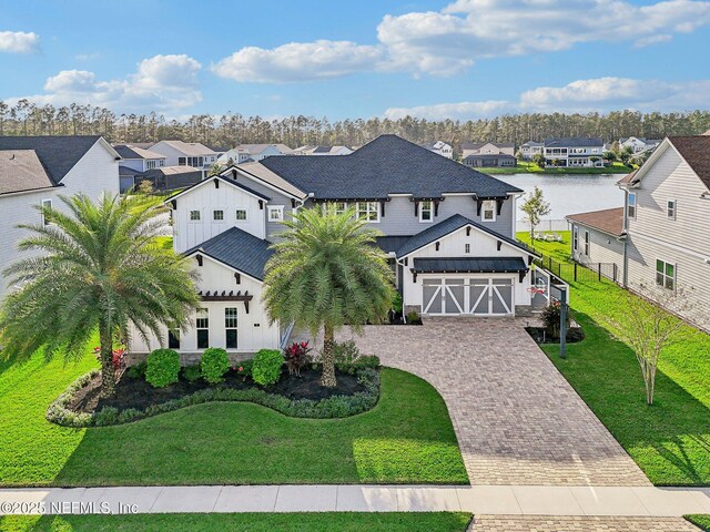 view of front of house with a water view and a front yard