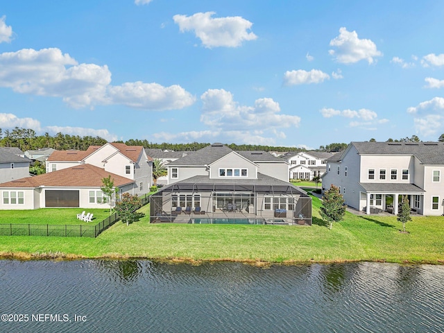 exterior space featuring a water view, glass enclosure, and a lawn