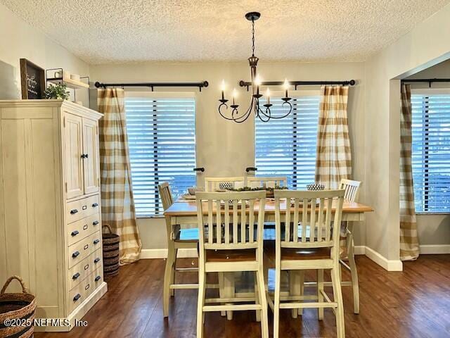 dining area featuring a textured ceiling, a chandelier, and dark hardwood / wood-style floors