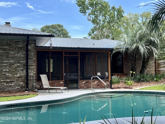 view of pool with a sunroom