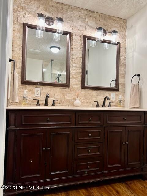 bathroom featuring vanity, a textured ceiling, and hardwood / wood-style flooring