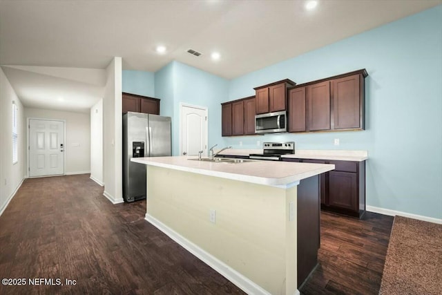 kitchen featuring a kitchen island with sink, sink, stainless steel appliances, and dark hardwood / wood-style floors