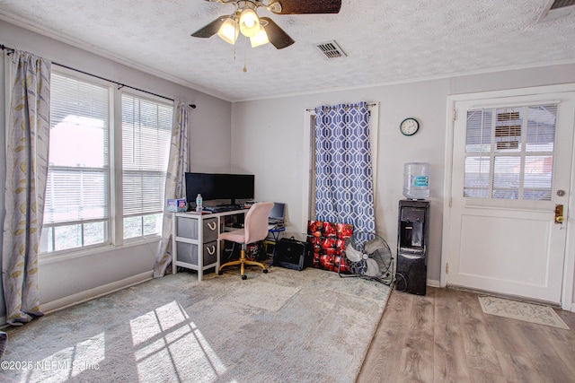 office area with ceiling fan, light wood-type flooring, and a textured ceiling