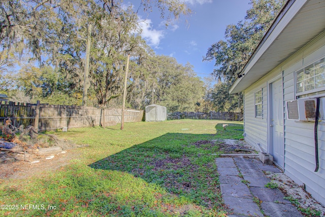 view of yard featuring cooling unit and a storage shed