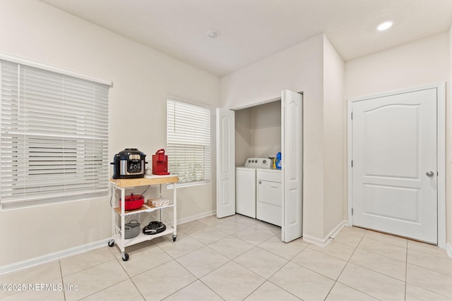 laundry room with light tile patterned floors and washing machine and clothes dryer