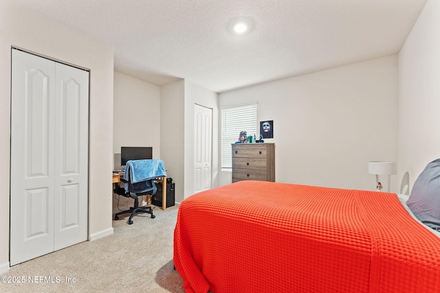 bedroom with carpet and multiple closets