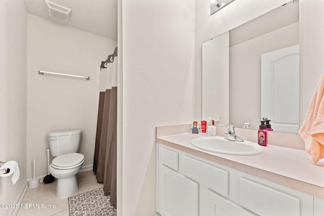 bathroom with tile patterned floors, vanity, and toilet