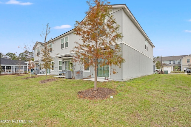 rear view of house with a lawn and central AC unit