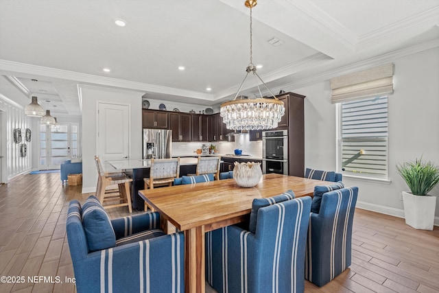 dining space featuring beamed ceiling and ornamental molding