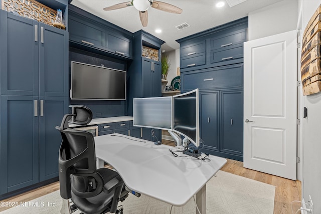 home office with ceiling fan and light hardwood / wood-style flooring