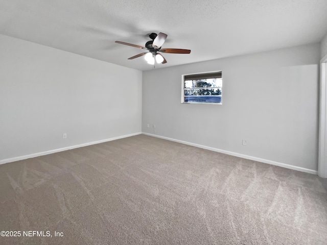 carpeted spare room featuring a textured ceiling and ceiling fan