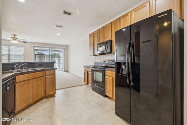 kitchen with ceiling fan, sink, black appliances, and a textured ceiling