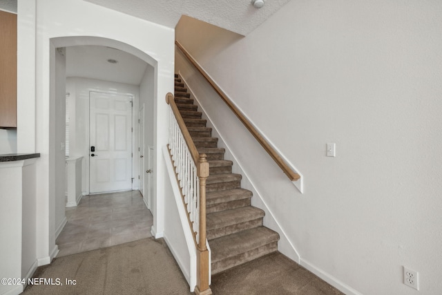 stairs featuring carpet