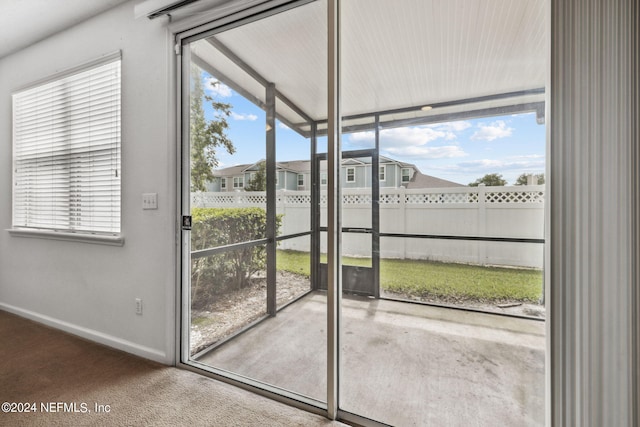 doorway to outside featuring carpet floors